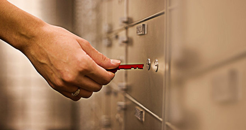 hand unlocking the deposit box of a deceased estate