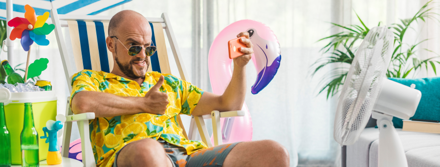Relaxing on a deck chair, a man captures a selfie with a big thumbs up.
